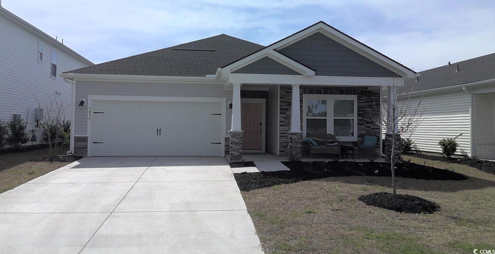 View of front facade with a garage, stone siding, 
