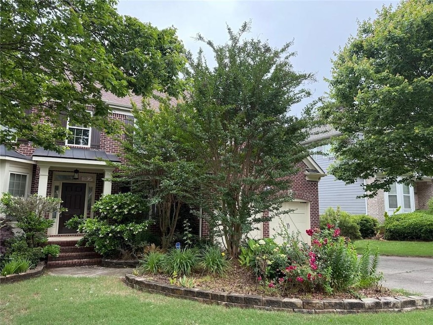 Obstructed view of property with brick siding
