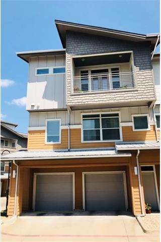 Townhouse-style corner condo with attached 2-car g