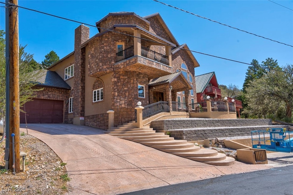 View of front of property with a garage and a balc