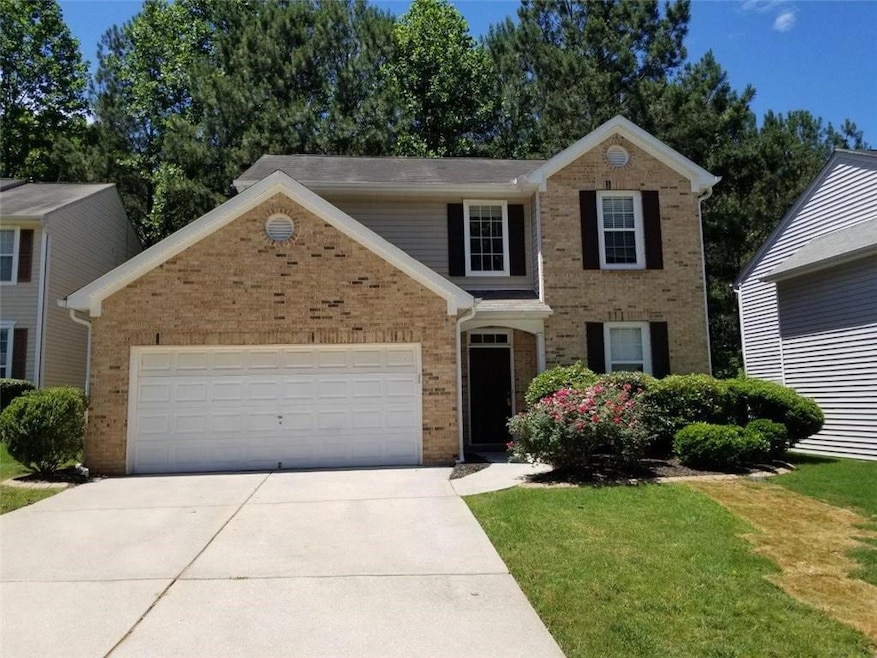 View of front facade featuring a garage and a fron