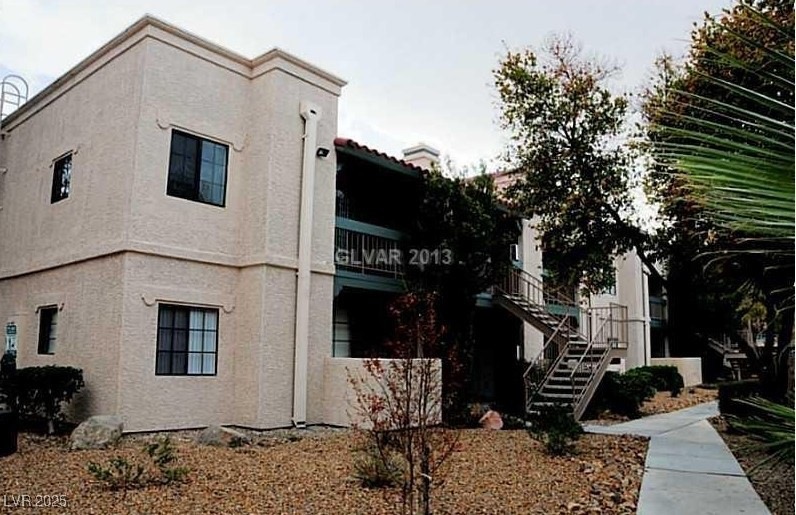 View of property exterior featuring stairs and stu