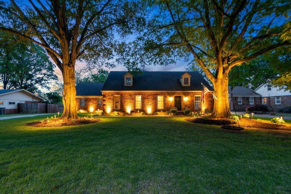 New england style home with a lawn and fence