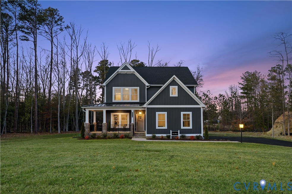 Craftsman house with a standing seam roof, a front lawn, a porch, a metal roof, and board and batten siding