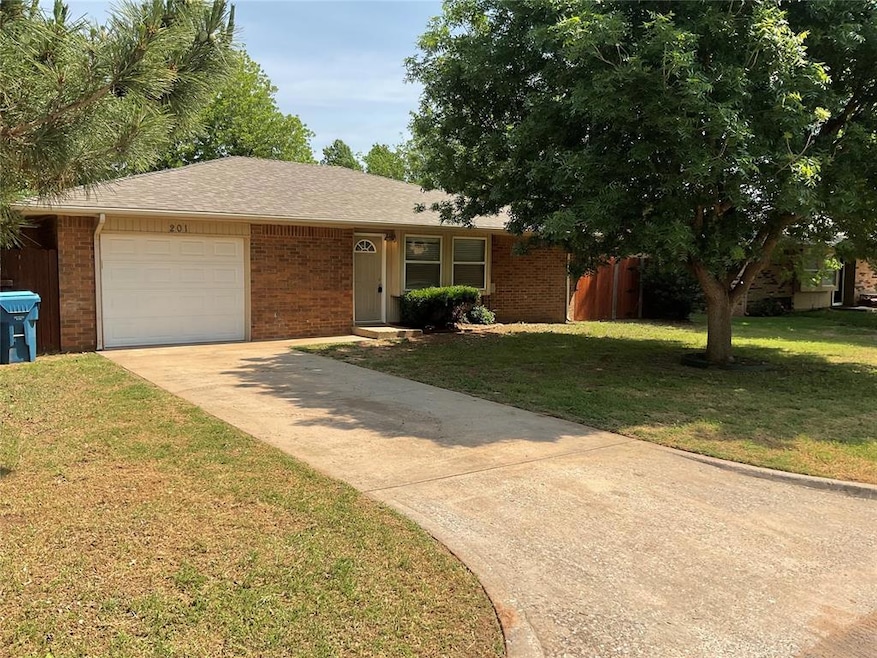 Ranch-style house with brick siding, a garage, and driveway