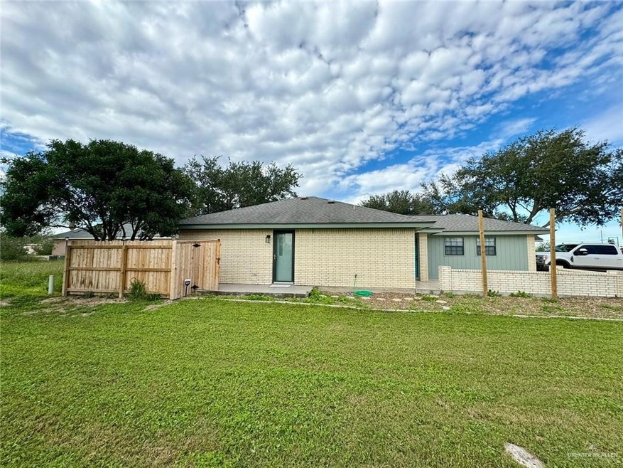Rear view of property featuring a lawn