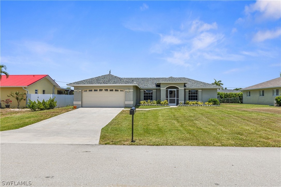 Single story home featuring a front lawn and a gar