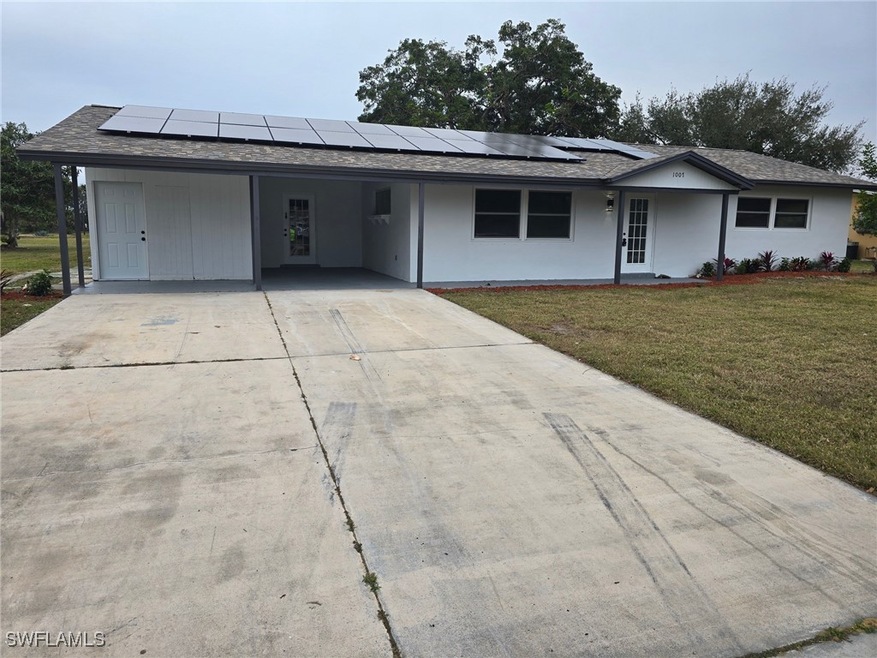 Ranch-style home with a front lawn and a carport