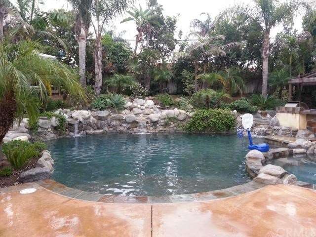 Tropical Pool/Spa Rear Yard with three cascading w