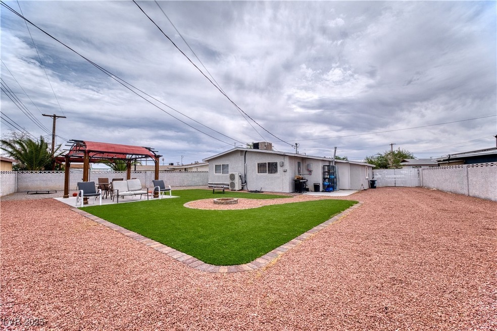 Back of house featuring a yard, a fenced backyard,