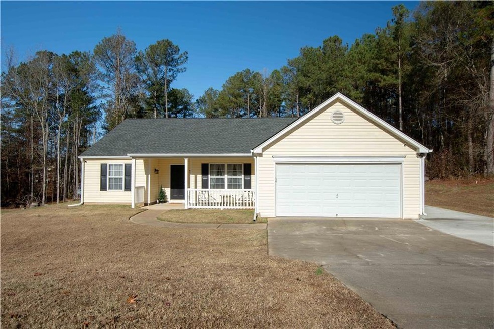 Ranch-style home with a garage and covered porch