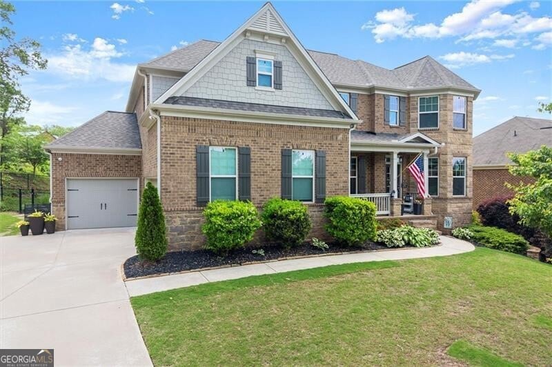 View of front of home featuring a porch, driveway,