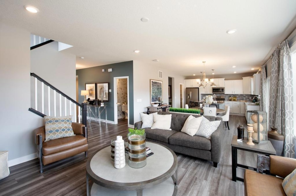 Game time view from the great room as it opens to the dining room and kitchen! (model photo) finishes will vary