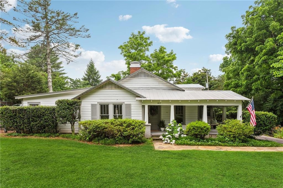 View of front of home with a front lawn, a wooden 