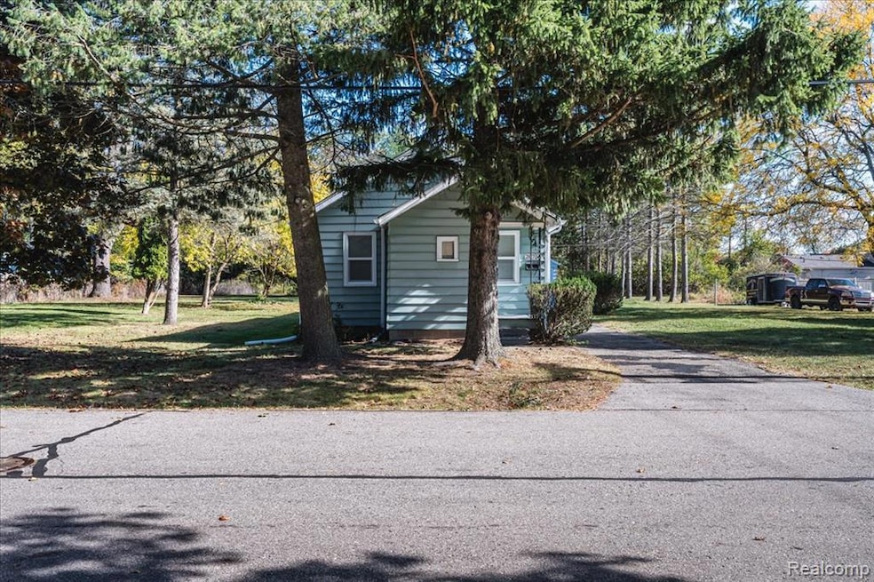View of property exterior featuring a yard