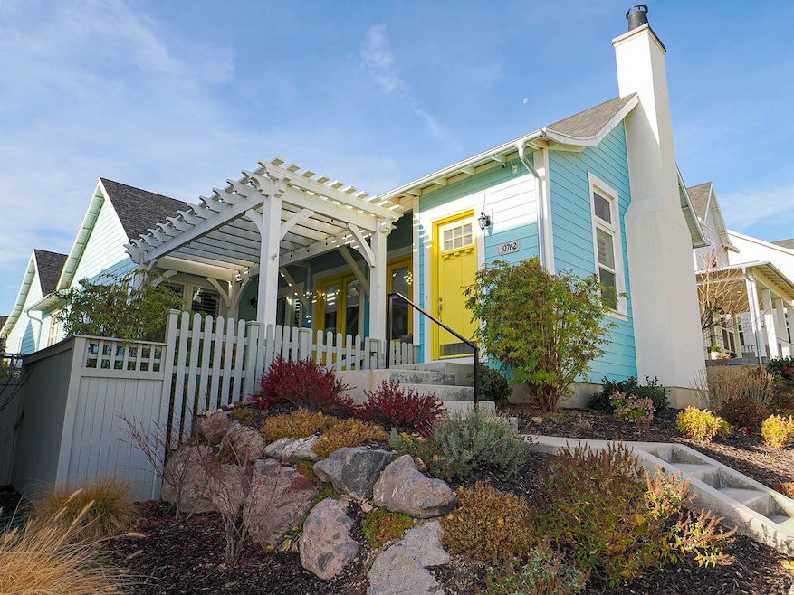 View of front of house with a chimney, a pergola, and a shingled roof