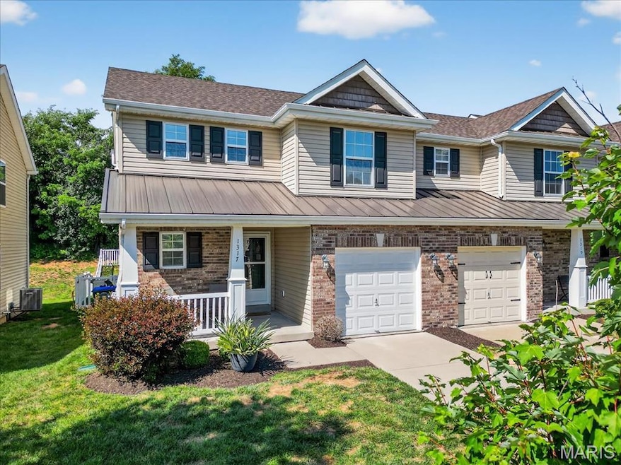 Craftsman inspired home featuring brick siding, a porch, a front lawn, and an attached garage