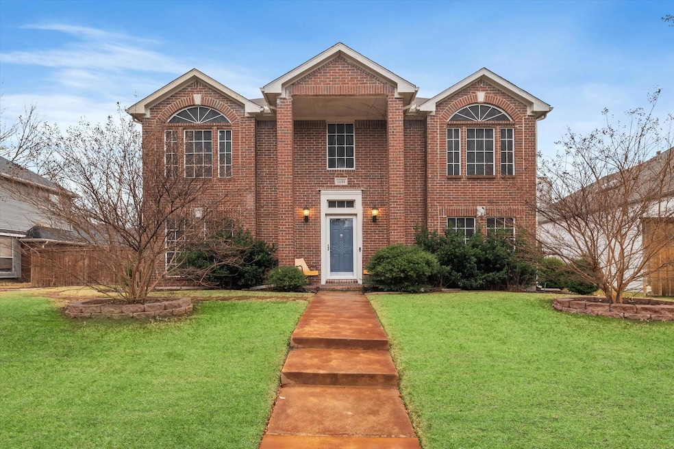 Traditional-style house featuring brick siding and