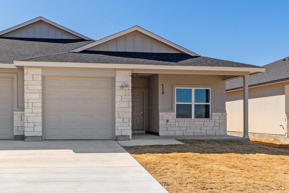 Ranch-style house featuring stone siding, a shing