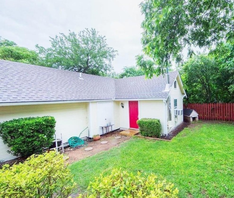 Rear view of house featuring a shingled roof