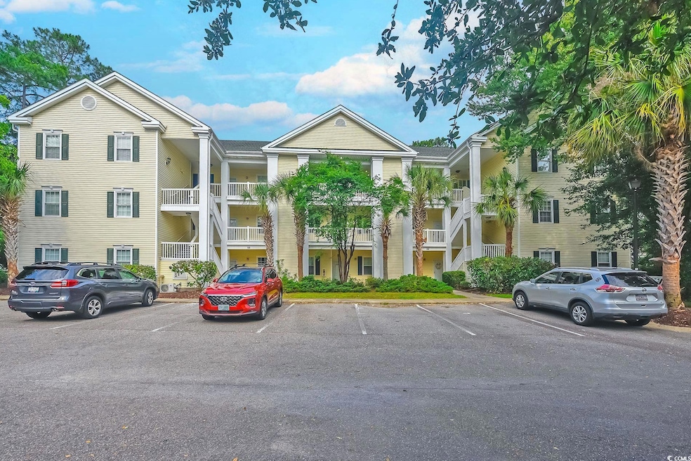 View of property featuring uncovered parking