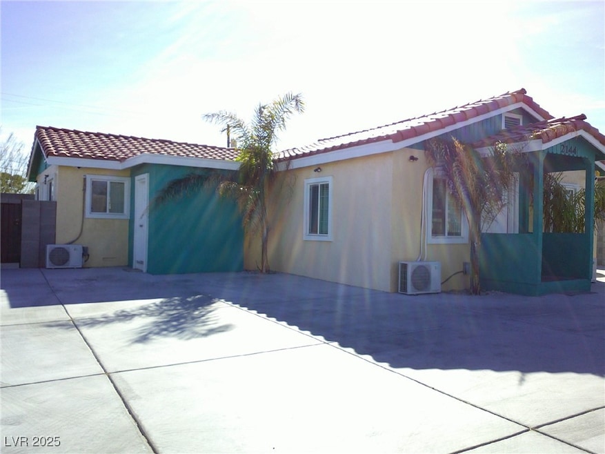 View of front of property with ac unit, a tile roo