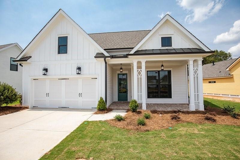 Modern inspired farmhouse with covered porch and a
