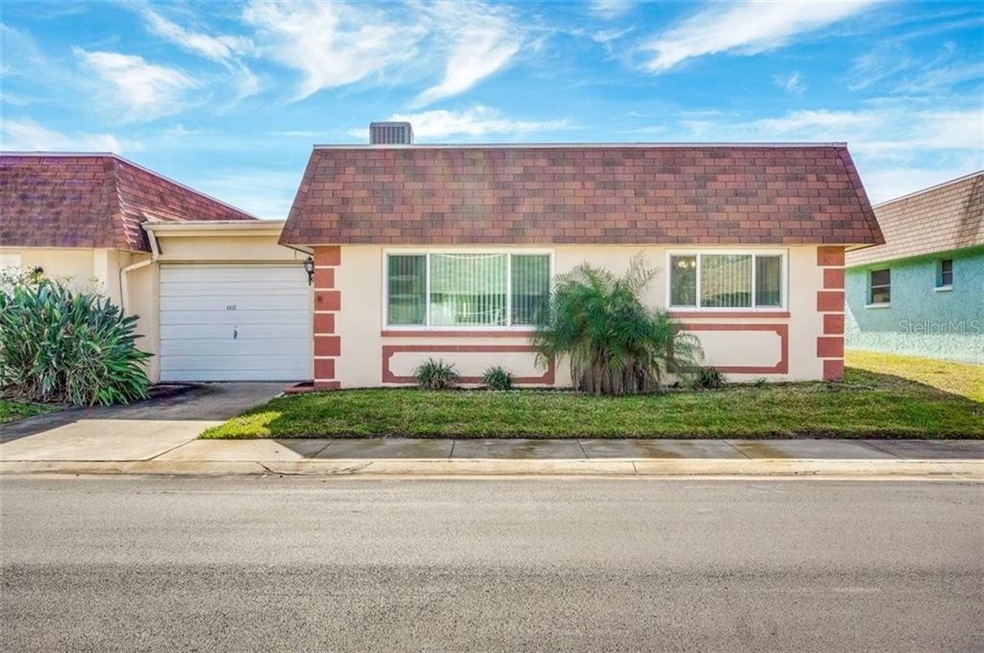 Front of condo. One car garage attached