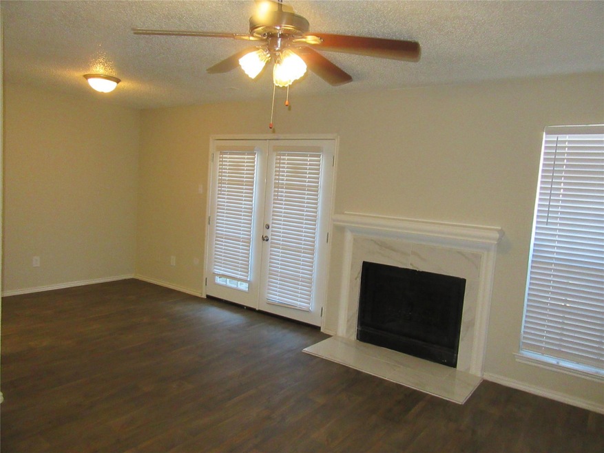 Unfurnished living room with a high end fireplace,
