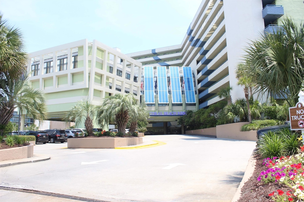 View of building exterior featuring uncovered parking