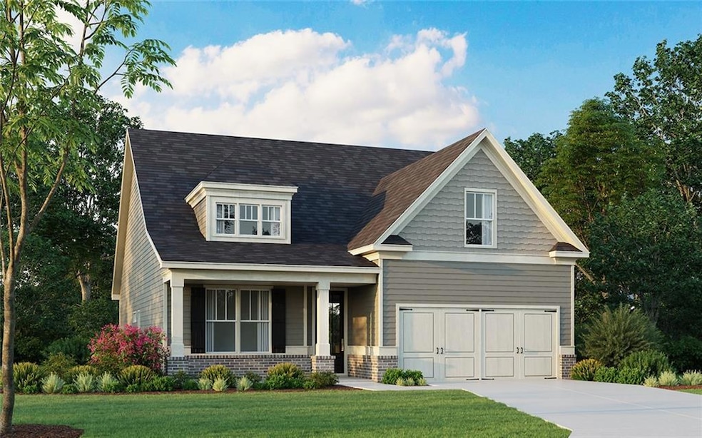 Craftsman house with brick siding, a front yard, a garage, and concrete driveway