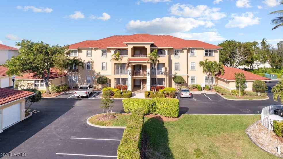 View of property featuring uncovered parking and a