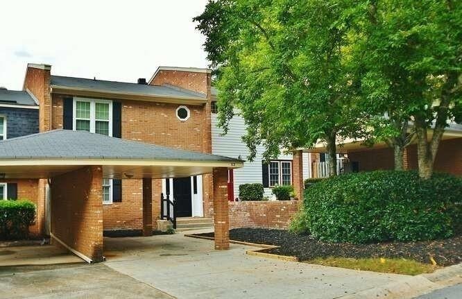 View of front of home featuring brick siding and concrete driveway