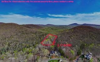 Birds eye view of property featuring a wooded view