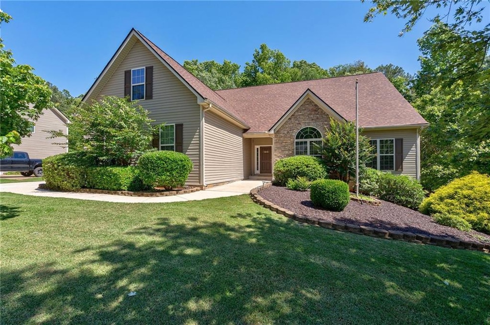 View of front of property featuring a front lawn and roof with shingles