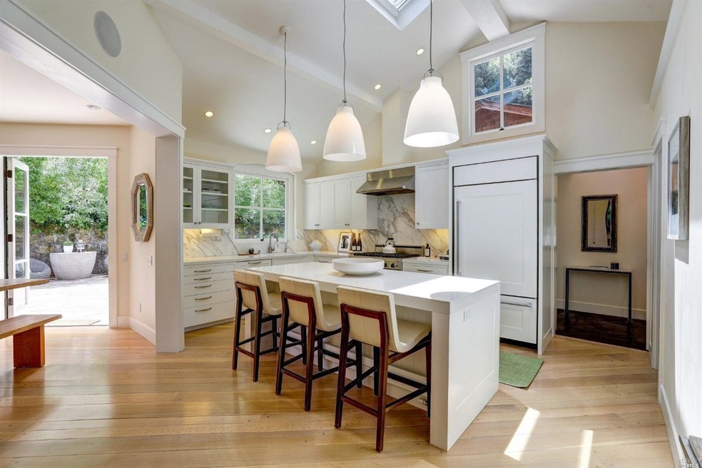 Stunning kitchen features vaulted ceilings, skylig
