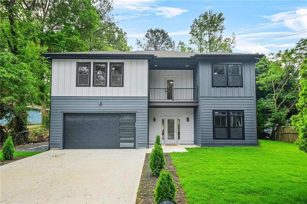Modern farmhouse featuring fence, an attached gara