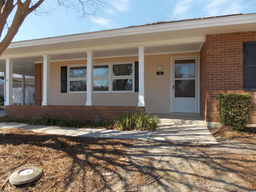 Entrance to property featuring a porch and brick s