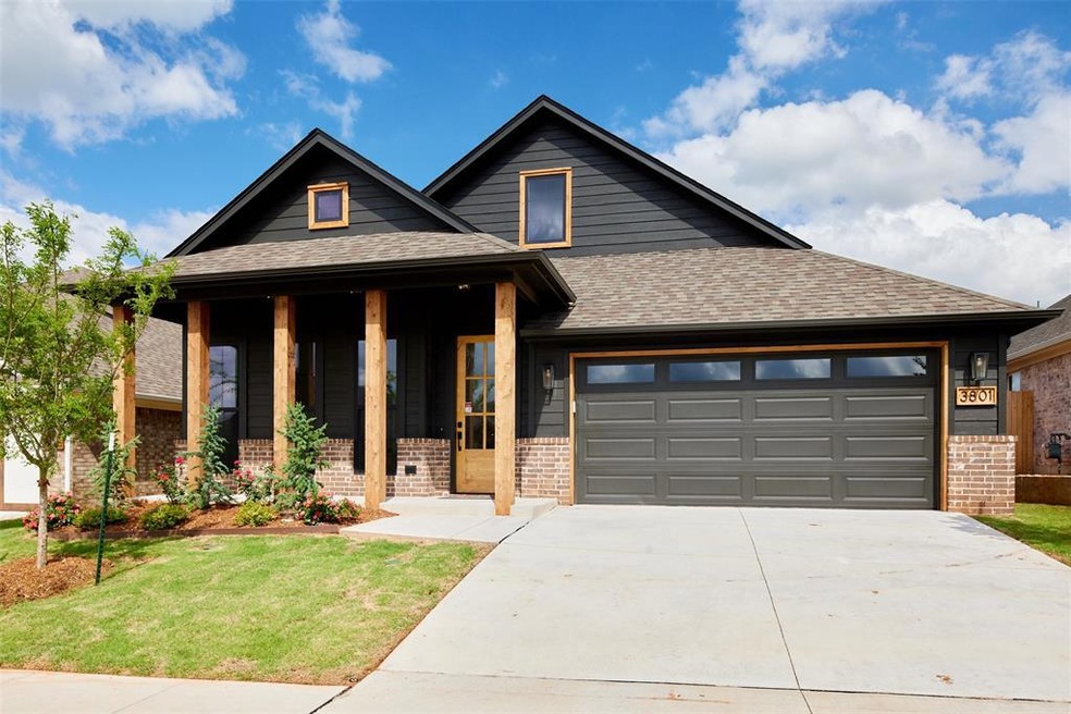 View of front of home with a front lawn and a gara