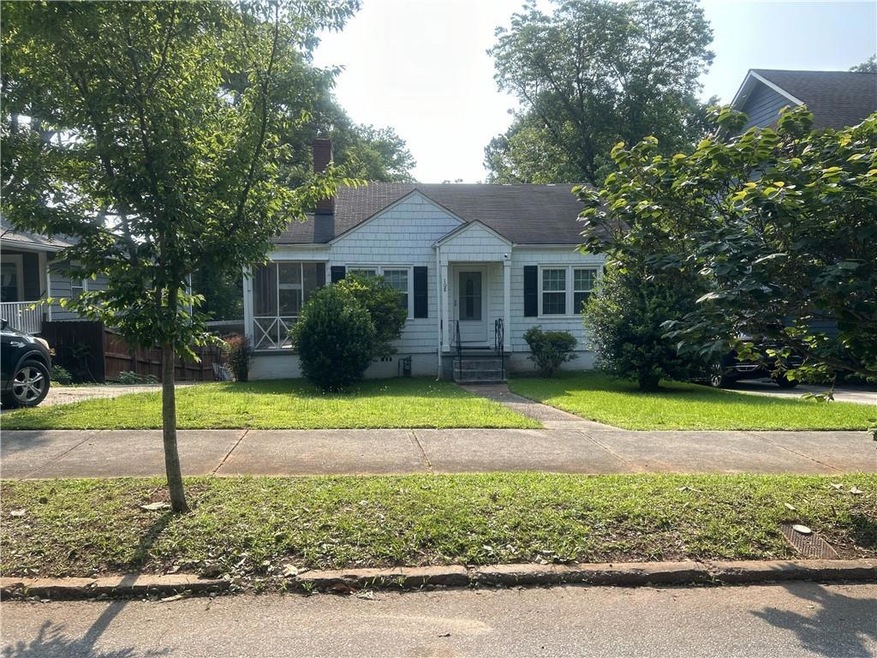 View of front facade with a front lawn and entry steps
