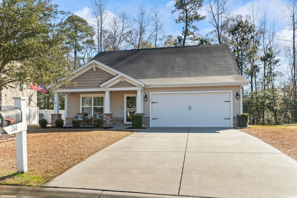 Craftsman-style house featuring a porch and a gara