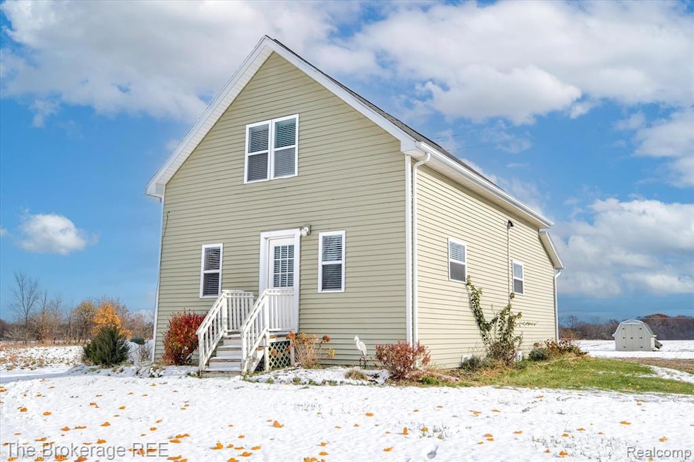 View of snow covered back of property