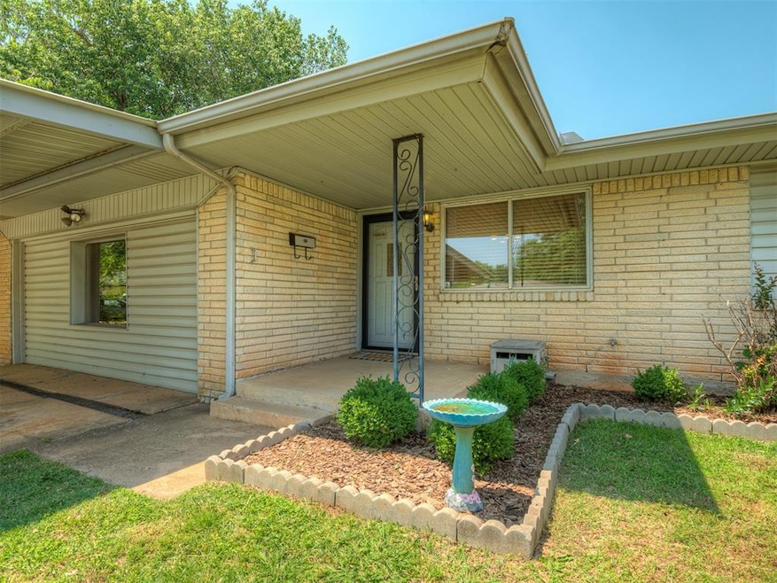 Doorway to property featuring brick siding and covered porch