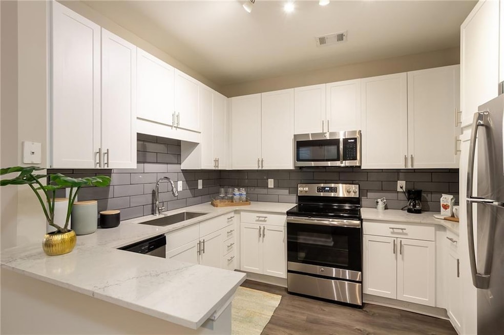 Kitchen with sink, appliances with stainless steel