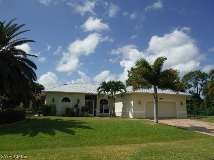 Front of home. Metal roof. 3 lot site.