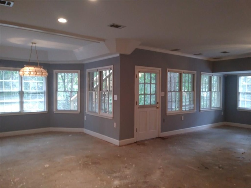 I just had to show the mega daylight... windows everywhere!!  It doesn't seem like a basement at all..  Just outside the door is a lovely covered patio.  So private.  Pool table on the left..  The carpeting has been pulled and it would be so easy to 