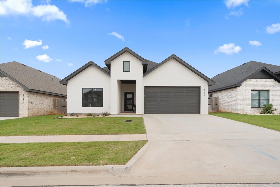 View of front of property featuring a garage and a