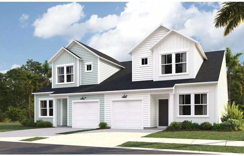 View of front of property featuring driveway, a garage, and board and batten siding
