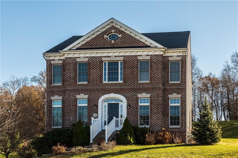 The front exterior showcases a brick front and an 