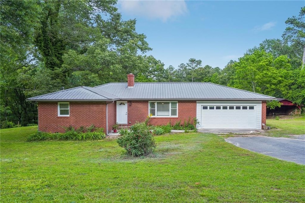 Ranch-style house with driveway, an attached garag